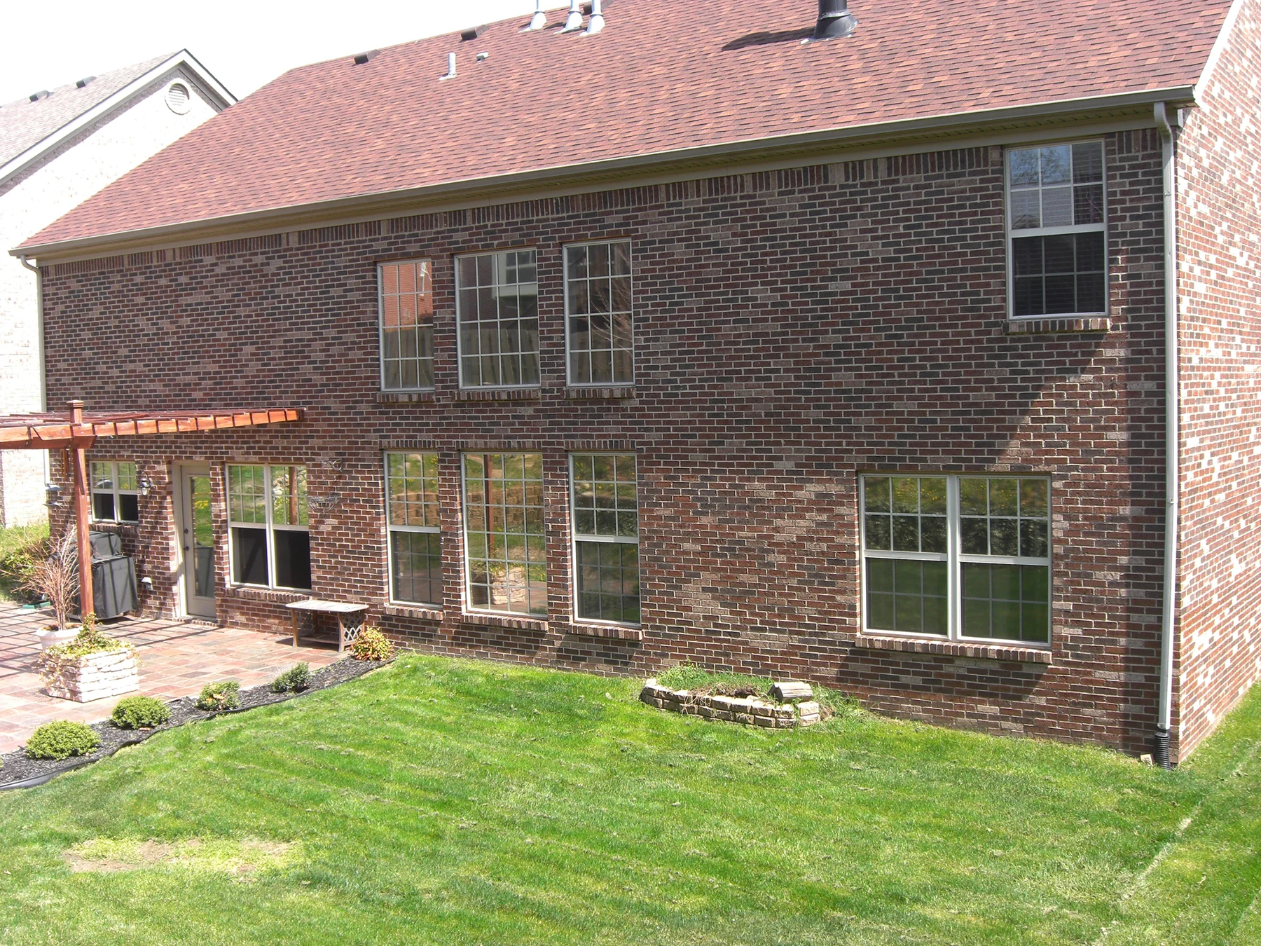 Rear brick exterior and backyard patio
